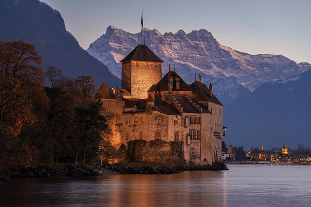 Chillon Château at nightfall with the Dents du Midi in the background. Image: Giles Laurent